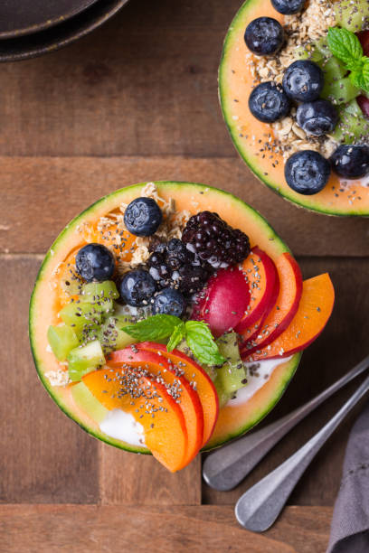 istock Fruit salad with yogurt in carved melon cantaloupe bowl 1322101069