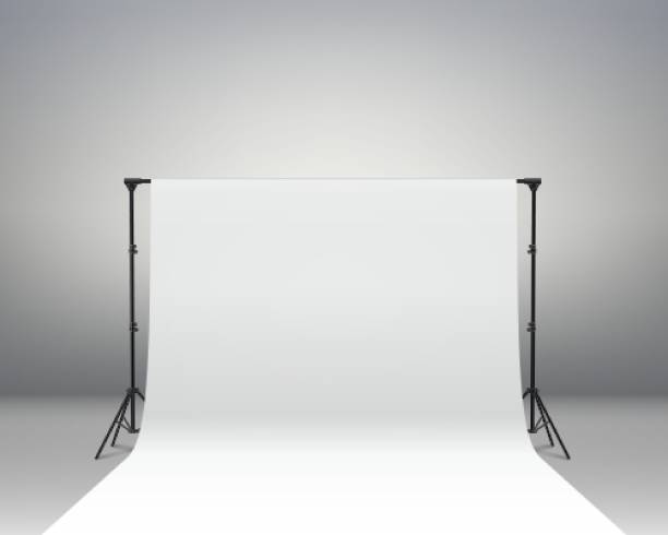 istock Professional photo studio interior. Photography tripods and racks and paper roll 1322101872