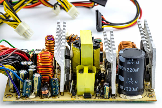 istock An open computer power supply at 220 volts with visible electronic components on the printed circuit board. 1322103074