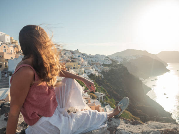 istock Woman contemplates Santorini from top, Greece 1322104853