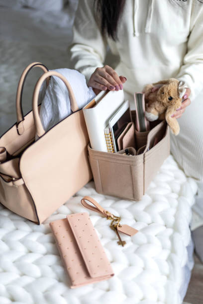 istock Closeup female hands putting business accessories into removable felt organizer for storage 1322106572