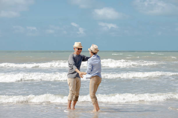 istock asian senior couple  dancing  on the beach 1322107283
