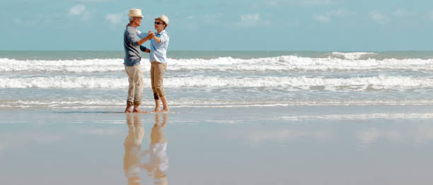 istock asian senior couple  dancing  on the beach 1322107347