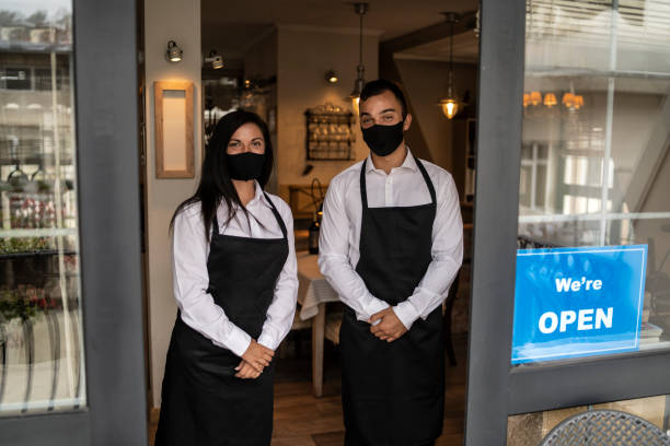 istock Ended lockdown and quarantine in small business. We're open Sign on a restaurant or cafe entrance. 1322108546