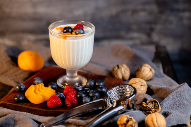 istock Still life: yogurt, fresh fruits and nuts on table 1322108736