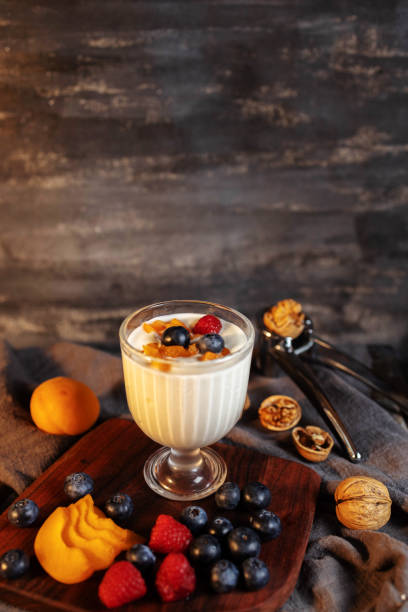 istock Still life: yogurt, fresh fruits and nuts on table 1322108741