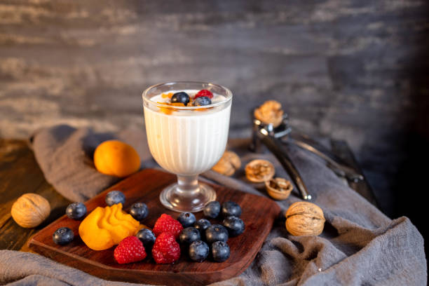 istock Still life: yogurt, fresh fruits and nuts on table 1322108784