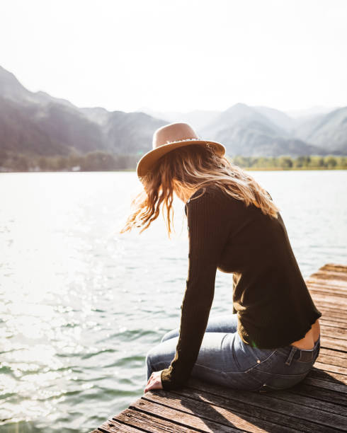 istock woman resting on the jetty at summer 1322109446