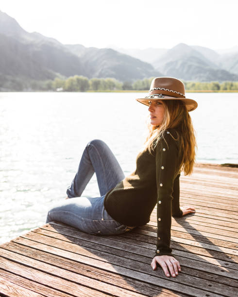 istock woman resting on the jetty at summer 1322109563