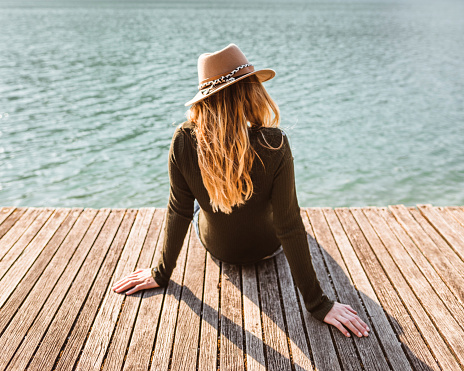 woman resting on the jetty at summer