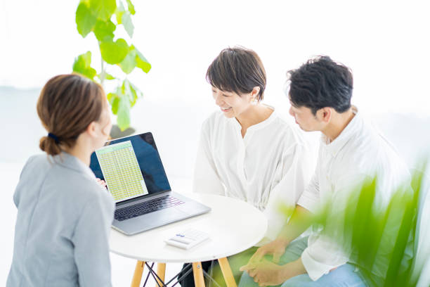 A couple receiving an explanation A couple receiving an explanation from a woman in a suit hello stock pictures, royalty-free photos & images