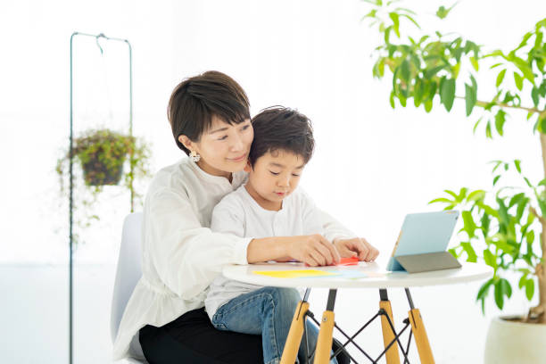 istock Mother and child doing origami 1322110865