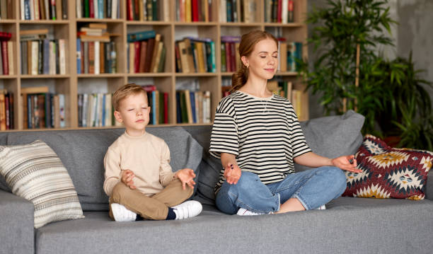 istock Peaceful mom and son meditating together while sitting in lotus 1322112415