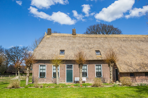 Old farmhouse with thatched roof in historic village Orvelte, Netherlands