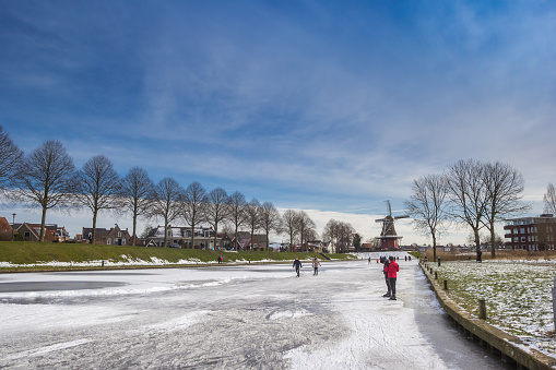 Frozen river leading to a windmill in Dokkum, Netherlands