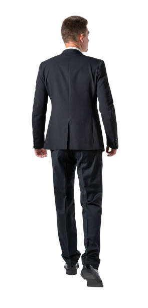 istock Rear view of young businessman walking forward, isolated 1322115174