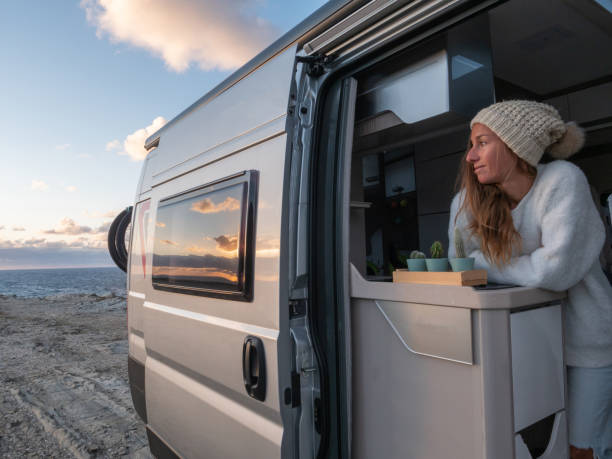 istock Woman looks at coastline from her van 1322115366