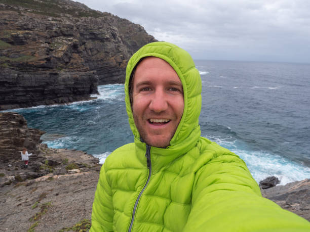 istock Man takes selfie on cliff in Sardinia 1322115404