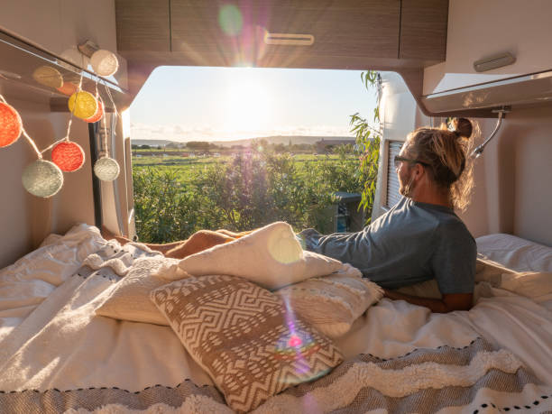 istock Man looks at sunset from his van 1322115617