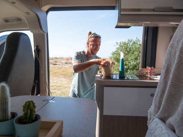 istock Man looks after cactuses in his van 1322116250