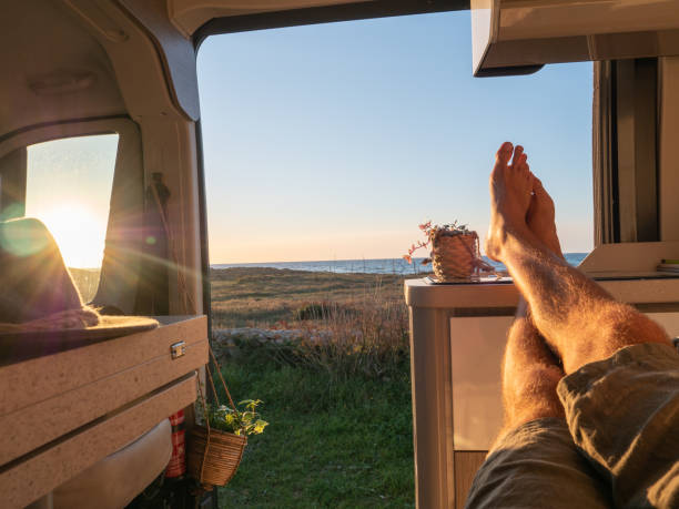 istock Man lying in a van looking at the ocean, POV 1322116462