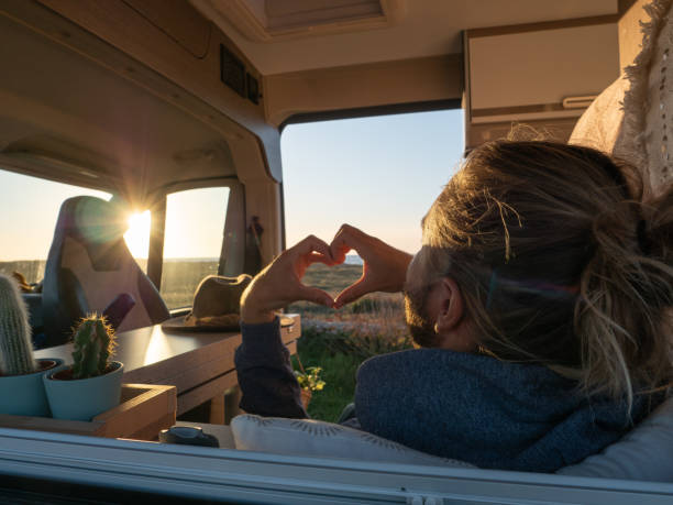 istock Man lying in a van loving the ocean view 1322116492
