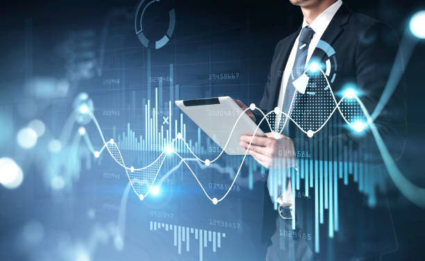 istock Businessman hands with tablet, graph changes lines and bars with numbers 1322117170