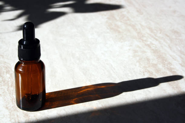 istock Cosmetic glass bottle on marble background. 1322122131