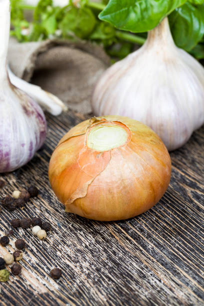 istock ripe yellow onions on the kitchen table during cooking, 1322131022