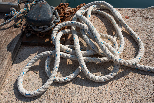 Pulley with ropes of a classic sailing boat and blue sea water