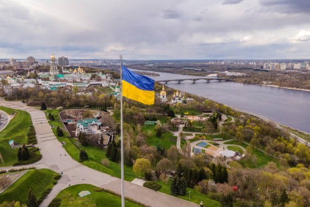 Aerial top view by drone of Ukrainian flag waving in the wind against the city Kyiv, Ukraine. Aerial top view by drone of Ukrainian flag waving in the wind against the city Kyiv, Ukraine. ukrainian flag photos stock pictures, royalty-free photos & images