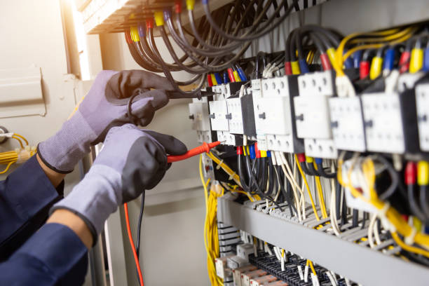istock Electrician engineer tests electrical installations and wires on relay protection system. Adjustment of scheme of automation and control of electrical equipment. 1322135466