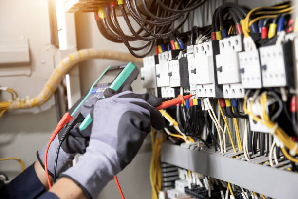 istock Electrician engineer tests electrical installations and wires on relay protection system. Adjustment of scheme of automation and control of electrical equipment. 1322135473