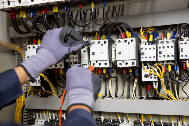 istock Electrician engineer tests electrical installations and wires on relay protection system. Adjustment of scheme of automation and control of electrical equipment. 1322135482