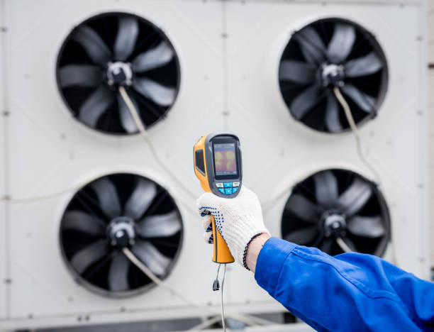 istock Technician uses a thermal imaging infrared thermometer to check the condensing unit heat exchanger. 1322138272