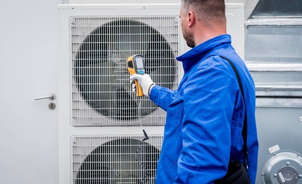 istock Technician uses a thermal imaging infrared thermometer to check the condensing unit heat exchanger. 1322138985