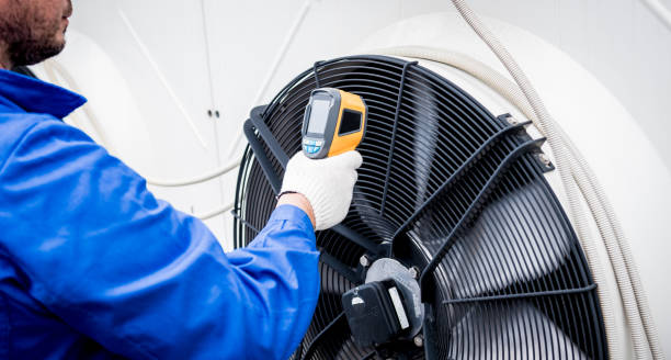 Technician uses a thermal imaging infrared thermometer to check the condensing unit heat exchanger.