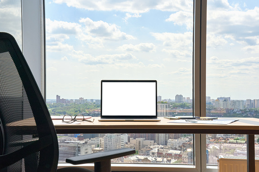 Workplace in modern office with blank empty mockup screen pc laptop computer.