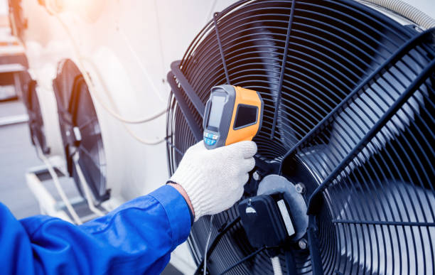 istock Technician uses a thermal imaging infrared thermometer to check the condensing unit heat exchanger. 1322139200