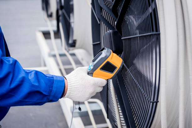istock Technician uses a thermal imaging infrared thermometer to check the condensing unit heat exchanger. 1322139251
