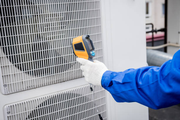 istock Technician uses a thermal imaging infrared thermometer to check the condensing unit heat exchanger. 1322139295