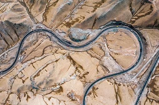 Aerial View of Rural Road through Mountains and Desert