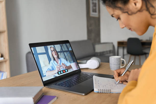 istock African American female student having video educational class on laptop. 1322140423