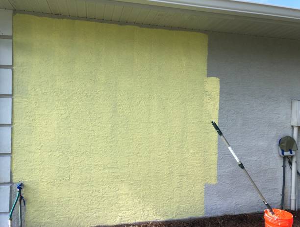 istock Wall Being Painted with Yellow Primer 1322142720