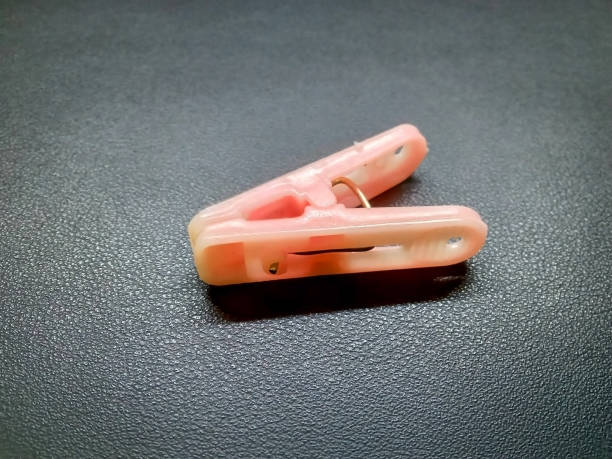 istock Pink clothespin on a black background photo 1322143234