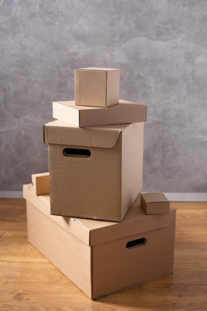 istock Cardboard boxes and things for moving to new home. Stack of cardboard box on floor background.  Move relocation into new house 1322143258
