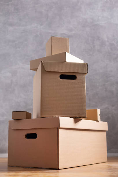 istock Cardboard boxes and things for moving to new home. Stack of cardboard box on floor background.  Move relocation into new house 1322143265