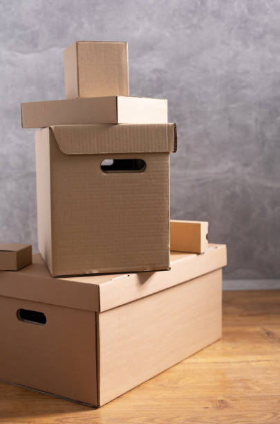 istock Cardboard boxes and things for moving to new home. Stack of cardboard box on floor background.  Move relocation into new house 1322143276