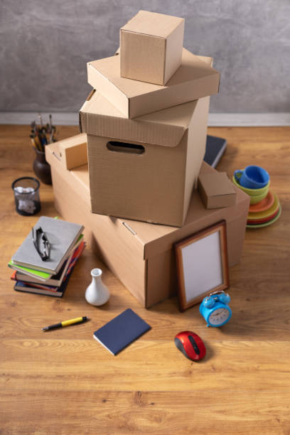 istock Cardboard boxes and things for moving to new home. Stack of cardboard box on floor background.  Move relocation into new house 1322143277