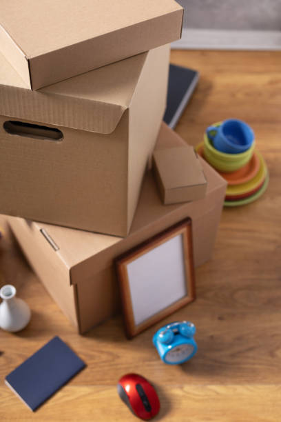 istock Cardboard boxes and things for moving to new home. Stack of cardboard box on floor background.  Move relocation into new house 1322143286
